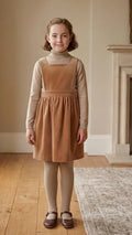 Fille portant le Patron PDF Robe Angélico du 2 au 14 ans, robe cache-cœur en velours camel sur manches longues crème