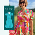 Femme portant le Patron PDF Robe Pelagia, motifs géométriques colorés, manches courtes, devant campagne verdoyante
