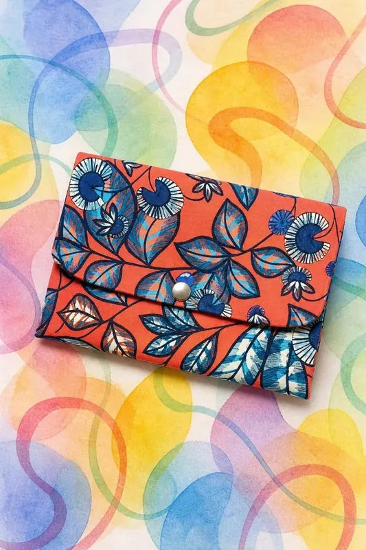 Pochette trop chouette en tissu orange à motifs bleus, avec rabat et bouton pression, patron PDF gratuit.