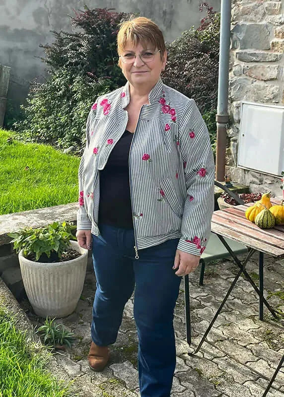 Femme portant le Patron PDF Bomber Phoenix, veste rayée à fleurs roses, vue de face en coton, terrasse jardin