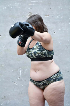 Femme en brassière de sport Punchy, prête pour une séance de boxe, affichant confort et style.