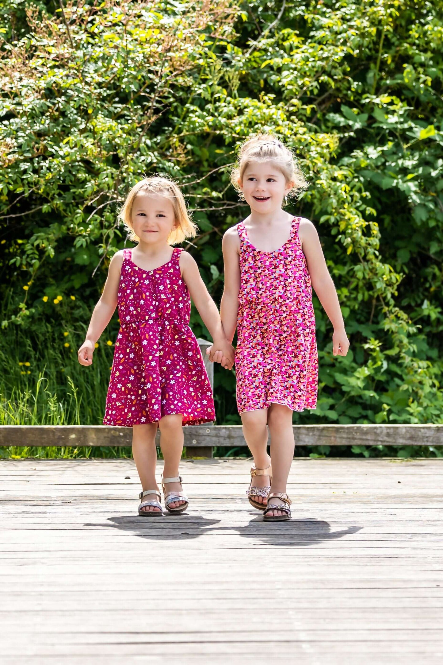 Deux filles portant CLEMENTINE - Le top et la robe d'été, patron de couture pdf à télécharger, marchant main dans la main.