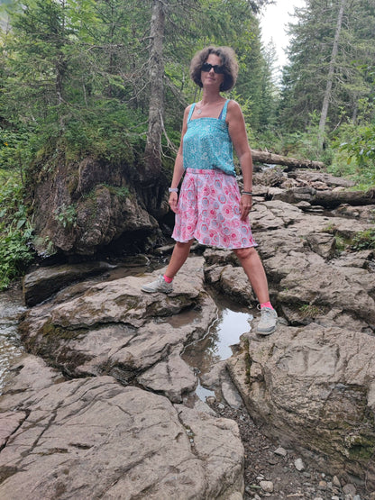 Femme en jupe-short LILAS, posant sur des rochers, parfait pour l'été, alliant confort et élégance.