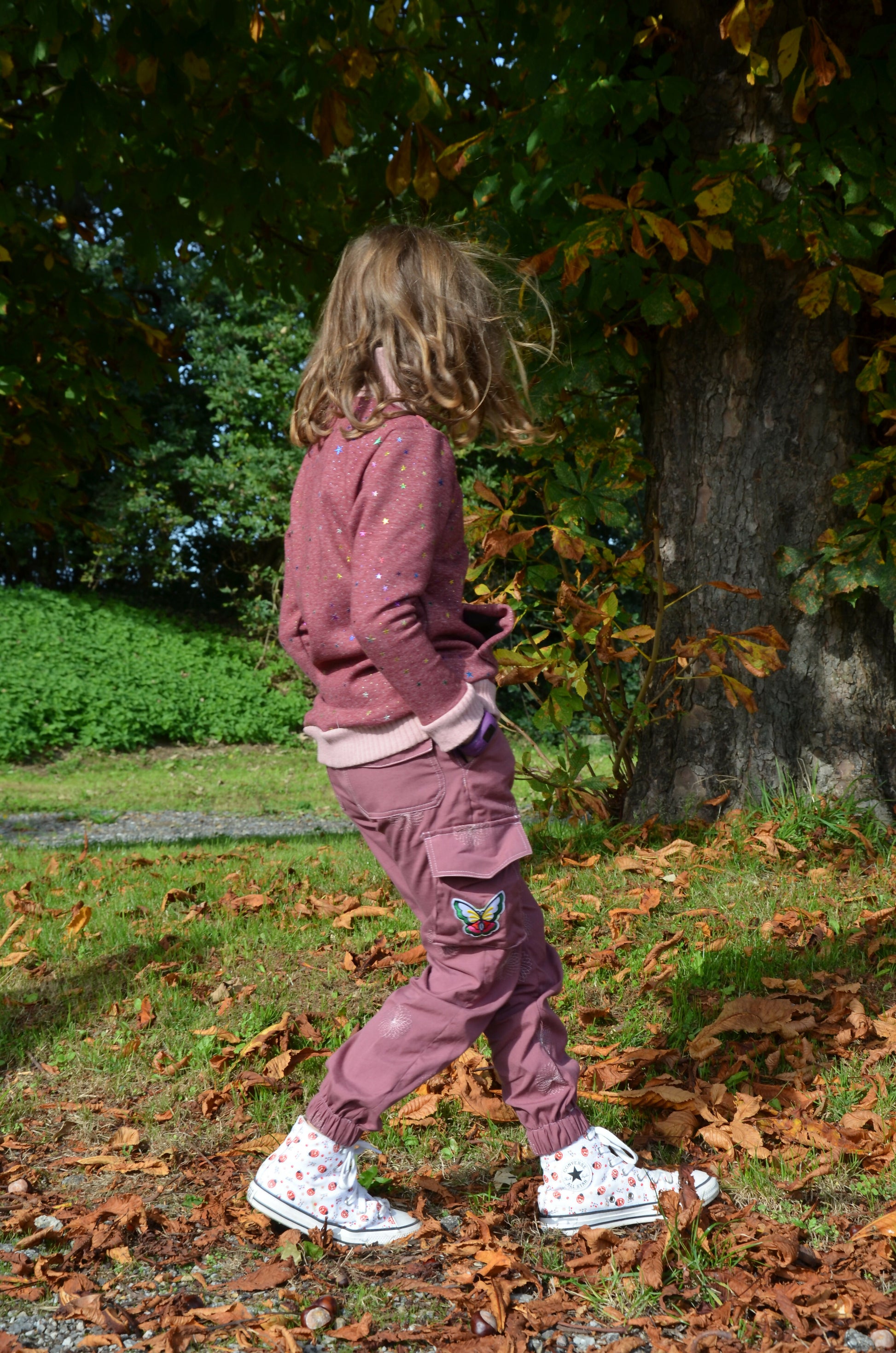 Enfant portant le Pantalon Enfant LAST rose, en promenade, avec patron de couture pdf à télécharger, style cargo tendance.