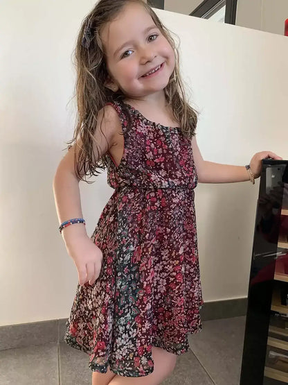 Robe Cylia Enfants portée par une petite fille, mettant en valeur le design floral et confortable.