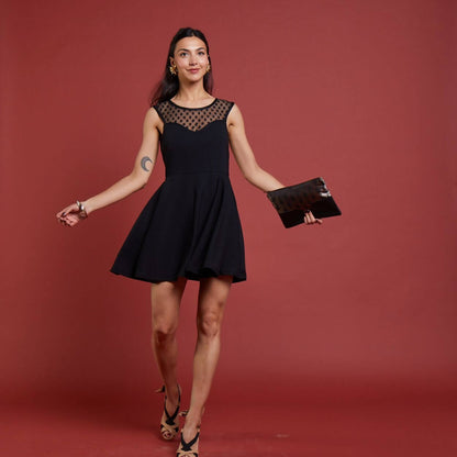 Femme portant la Robe La Coquette - T34 à 48 en noir, patron de couture PDF à télécharger, collection fête par Editions Marie-Claire.