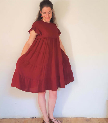 Femme portant la robe "Pansy" du 32 au 56, patron de couture pdf à télécharger, idéale pour l'été avec volants élégants.