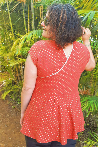 Femme portant le haut "Robe/Blouse Callisto - T36 à 50" dans un jardin, idéal pour l'été, patron de couture pdf à télécharger.