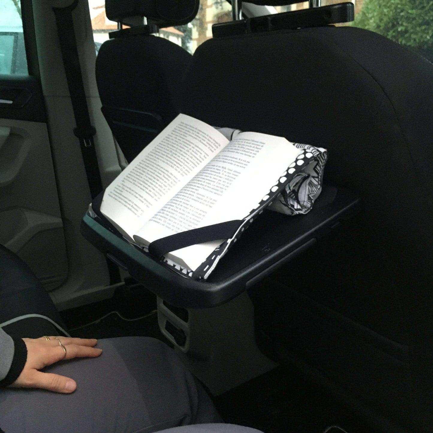 Support à livre – Lexie dans une voiture, tenant un livre ouvert avec des élastiques, idéal pour patron de couture pdf à télécharger.