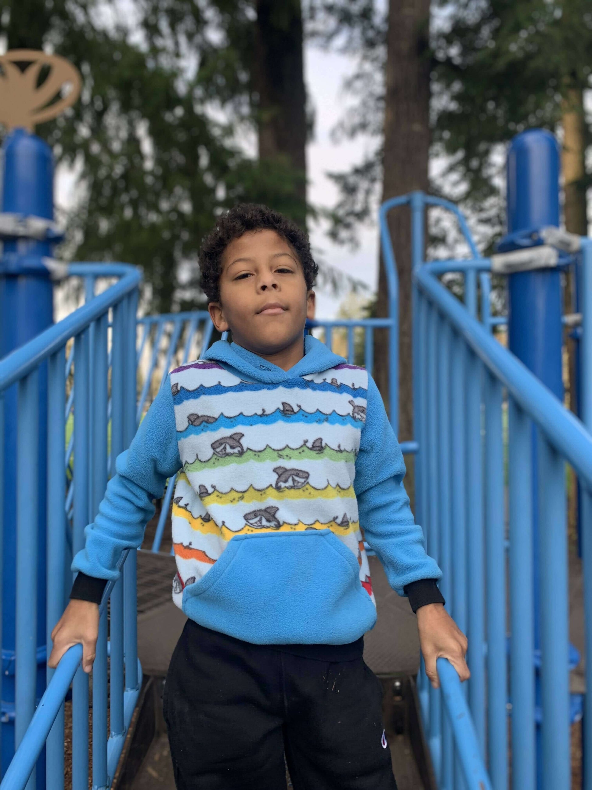 Enfant portant un sweat TITUS du 2 au 16 Ans avec capuche et poche kangourou, patron de couture PDF à télécharger.